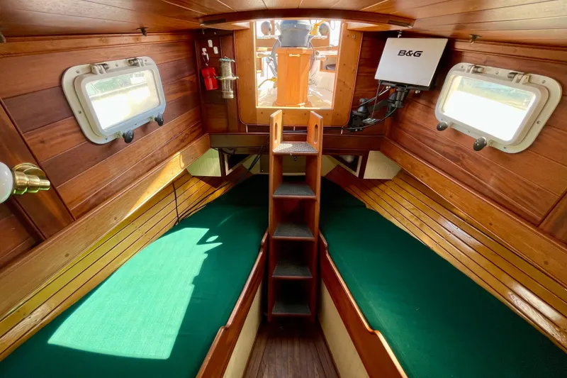 Slide: The Image of Cozy 2008 Pinky Custom boat cabin with wooden interior and green cushions. - 30