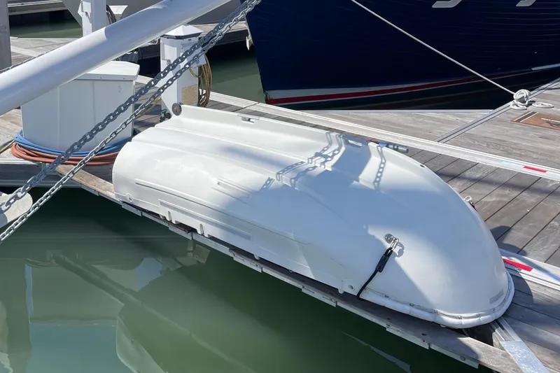 Slide: The Image of White Pinky Custom 2008 boat docked at marina, secured with chains. - 33