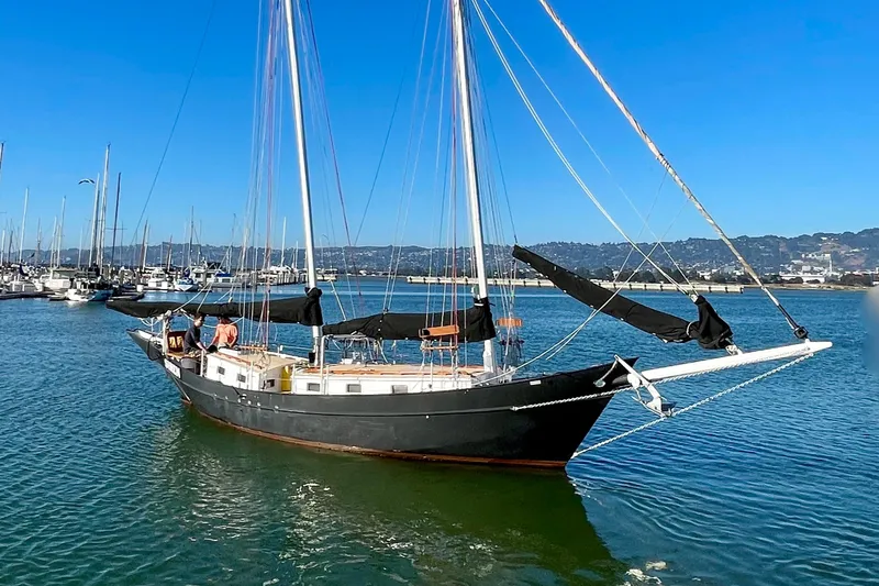 Slide: The Image of Custom 2008 Pinky sailboat docked in marina under clear blue sky. - 5