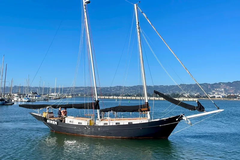Slide: The Image of Sailboat "Siren" on calm waters, Custom Pinky model, 2008, with clear blue sky. - 6