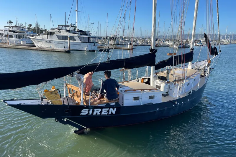 Slide: The Image of Sailing yacht "Siren" by Pinky Custom, 2008, docked in a marina with two people aboard. - 7