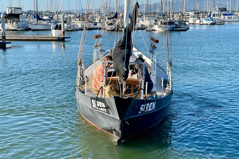 Slide: The Image of Sailboat "Siren" by Pinky, 2008 model, docked in a marina with clear blue water. - 9