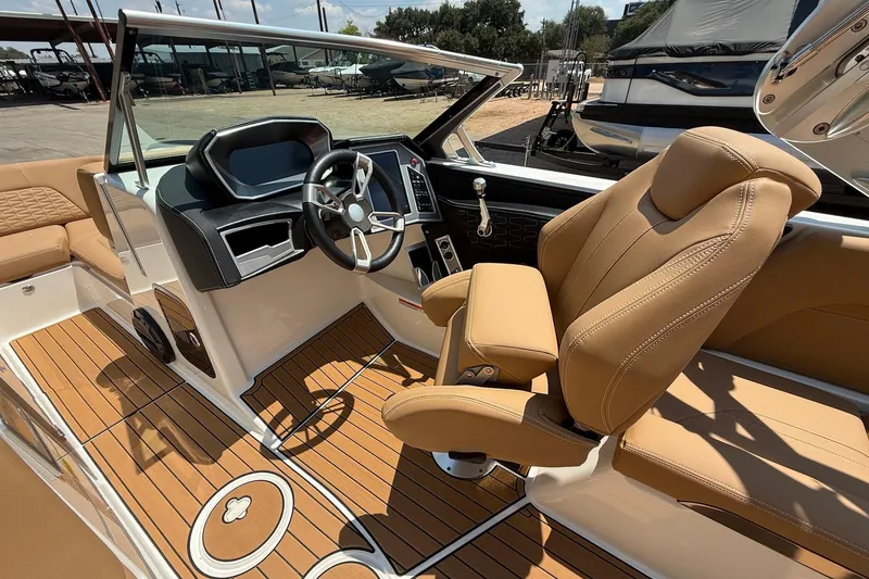 Slide: The Image of 2019 MasterCraft X24 boat interior with tan seats and modern dashboard. - 10