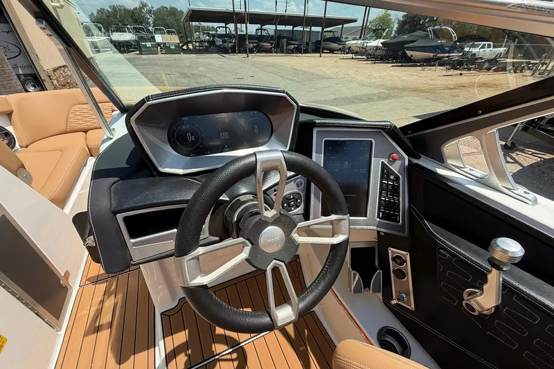Slide: The Image of 2019 MasterCraft X24 boat dashboard with modern controls and steering wheel. - 11