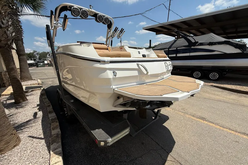 Slide: The Image of 2019 MasterCraft X24 boat on trailer, rear view, sunny day. - 5