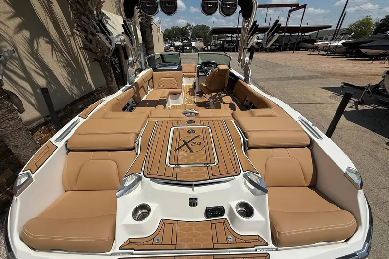 Slide: The Image of 2019 MasterCraft X24 boat interior with tan seating and sleek design. - 8