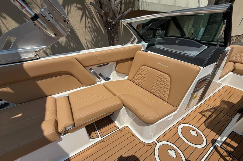 Slide: The Image of 2019 MasterCraft X24 boat interior with tan leather seating and teak-style flooring. - 9