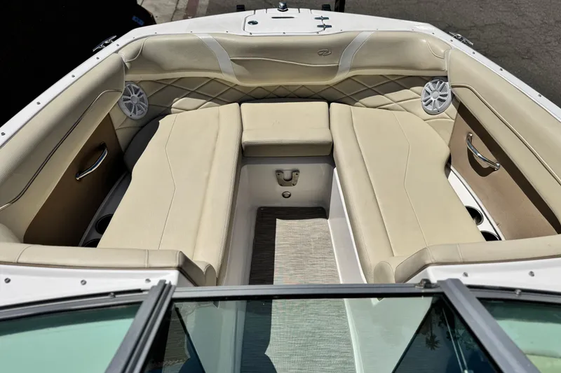 Slide: The Image of 2018 Regal 23 OBX boat interior with beige seating and built-in speakers. - 10