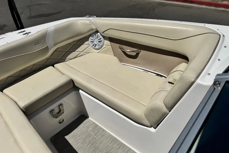 Slide: The Image of 2018 Regal 23 OBX boat interior with beige seating and speaker detail. - 12