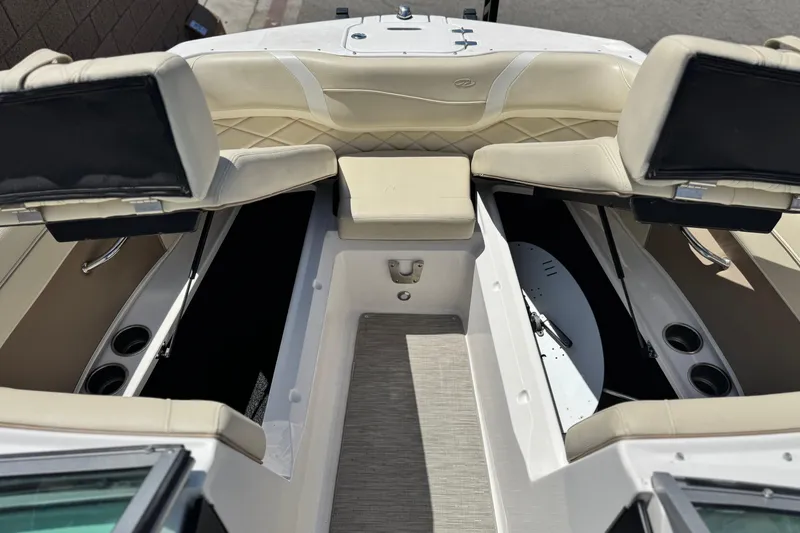 Slide: The Image of 2018 Regal 23 OBX boat interior with beige seating and storage compartments. - 15