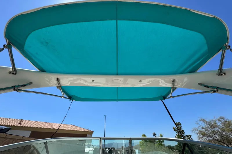Slide: The Image of 2018 Regal 23 OBX boat with turquoise canopy against clear blue sky. - 16