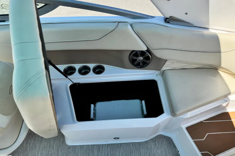 Slide: The Image of 2018 Regal 23 OBX boat interior with open storage compartment and cup holders. - 20