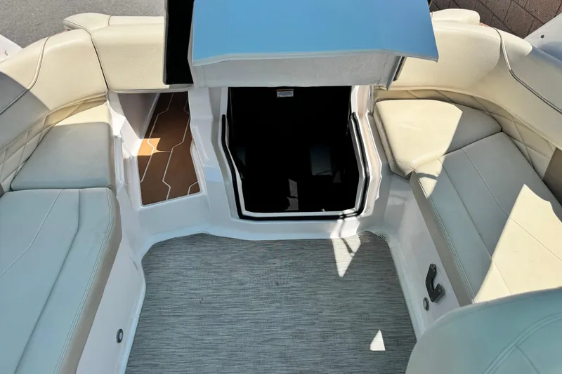 Slide: The Image of 2018 Regal 23 OBX boat interior with beige seating and open storage compartment. - 22