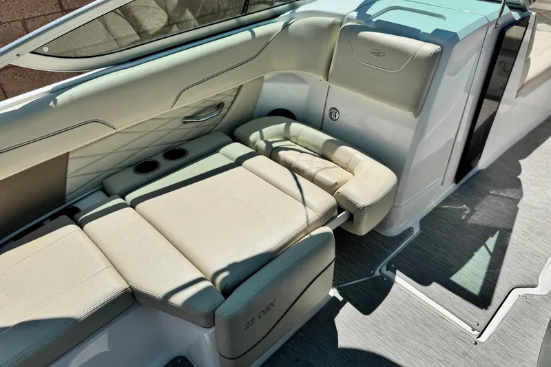 Slide: The Image of 2018 Regal 23 OBX boat interior with beige seating and cup holders. - 26