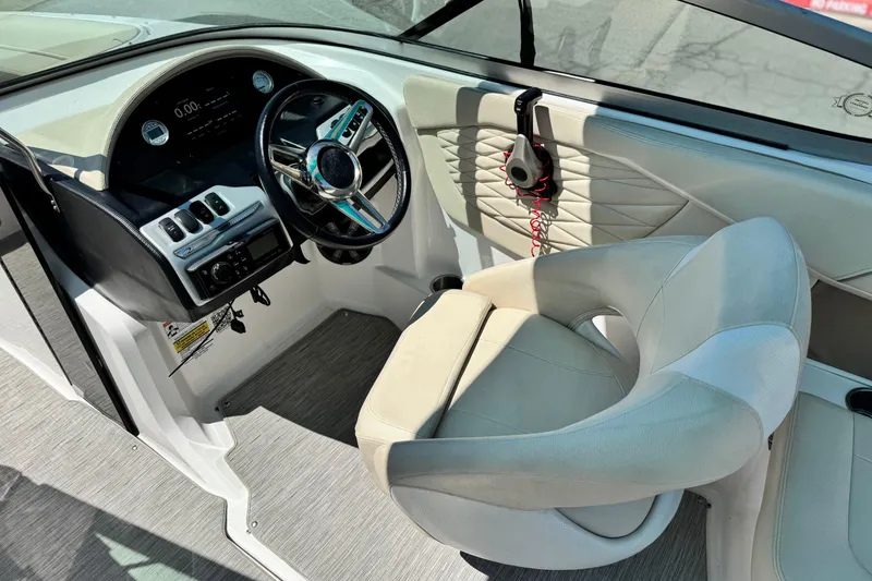 Slide: The Image of 2018 Regal 23 OBX boat interior with steering wheel and captain's chair. - 29