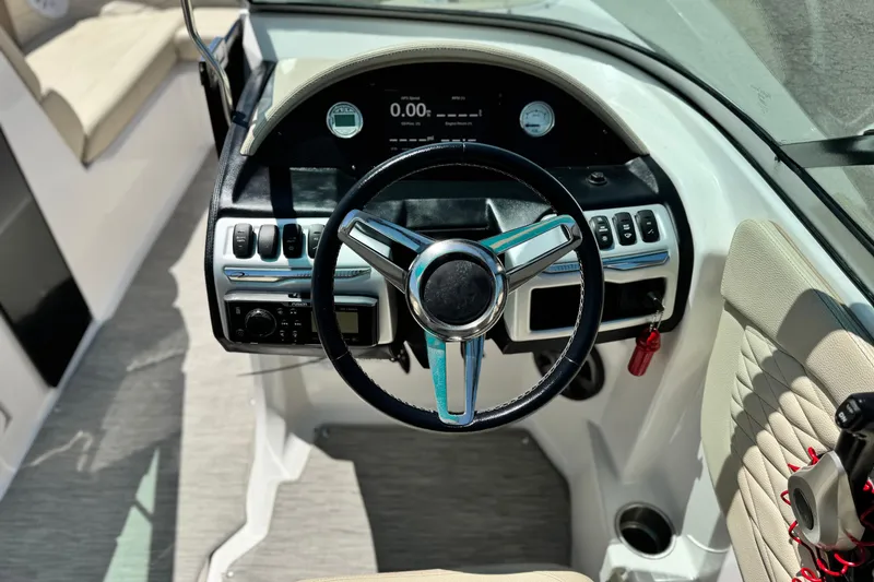 Slide: The Image of 2018 Regal 23 OBX boat dashboard with steering wheel and control panel. - 30