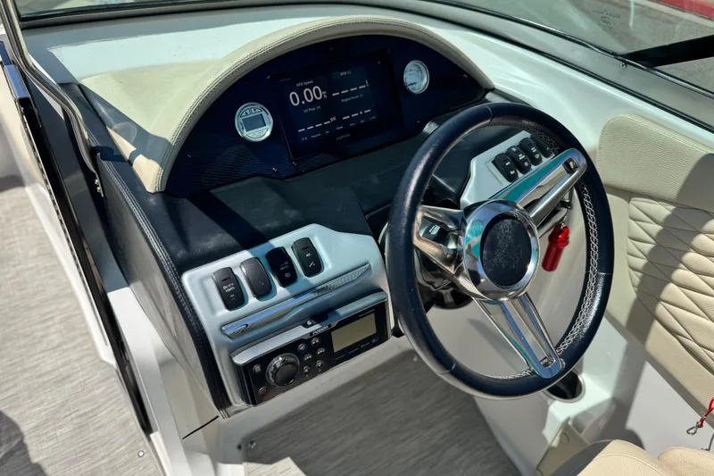 Slide: The Image of 2018 Regal 23 OBX boat dashboard with steering wheel and control panel. - 31