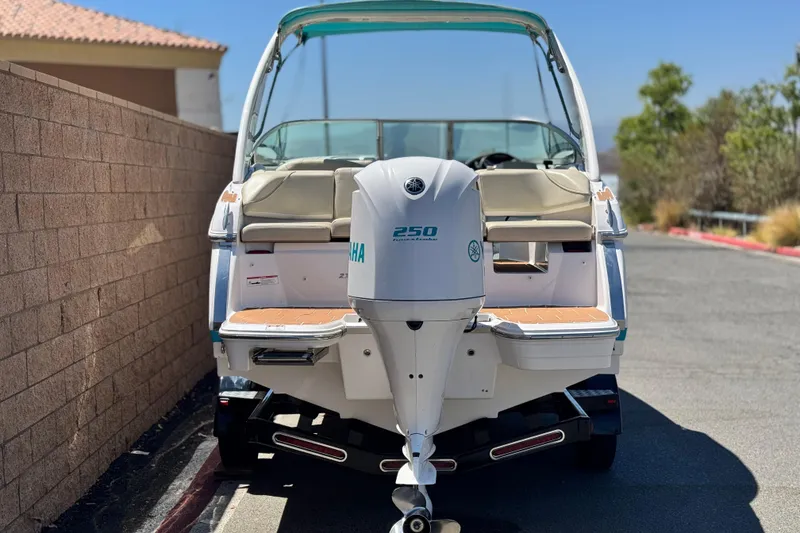 Slide: The Image of 2018 Regal 23 OBX boat with Yamaha 250 outboard motor, parked outdoors. - 4