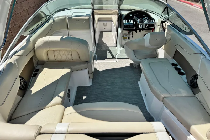 Slide: The Image of 2018 Regal 23 OBX boat interior with beige seating and modern dashboard. - 9