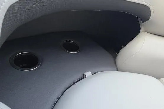 Slide: The Image of 2026 Sun Tracker PB 20 DLX boat interior with cup holders and cushioned seating. - 11