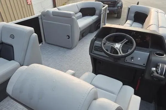 Slide: The Image of 2026 Sun Tracker PB 20 DLX pontoon boat interior with gray seating and steering console. - 14