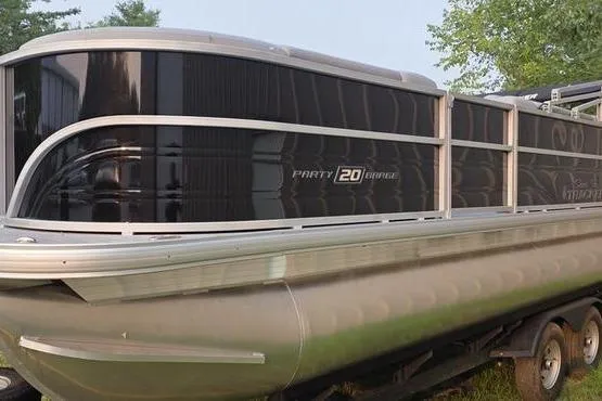 Slide: The Image of 2026 Sun Tracker PB 20 DLX pontoon boat on trailer, side view. - 6