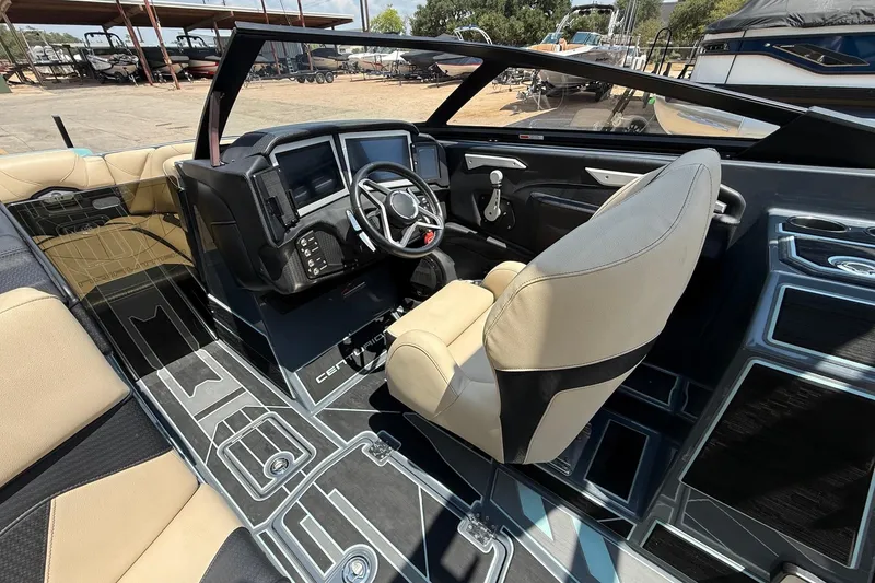Slide: The Image of 2022 Centurion Ri245 boat interior with modern dashboard and luxurious seating. - 10