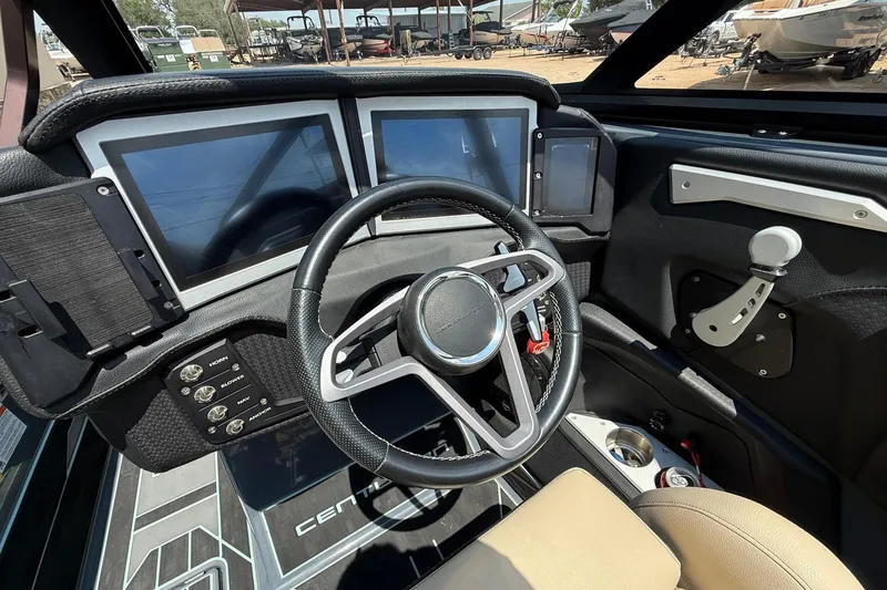 Slide: The Image of 2022 Centurion Ri245 boat dashboard with modern steering and digital displays. - 11