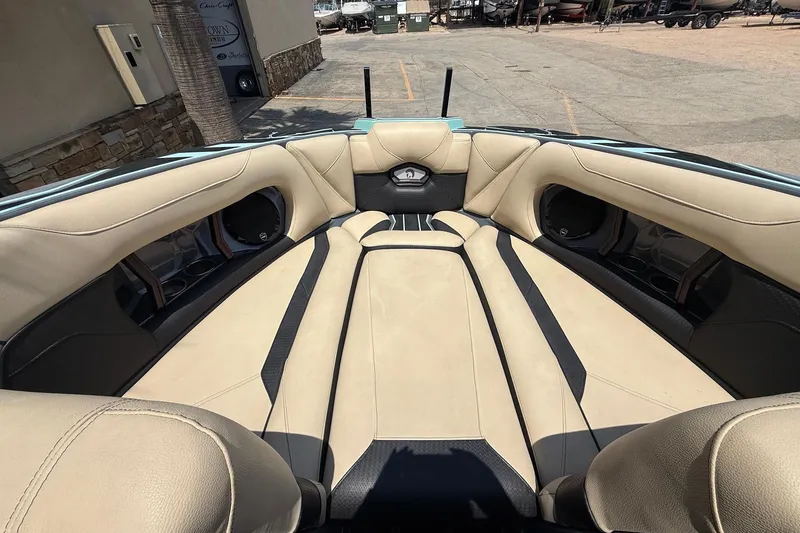 Slide: The Image of 2022 Centurion Ri245 boat interior with beige and black seating, showcasing luxury design. - 13