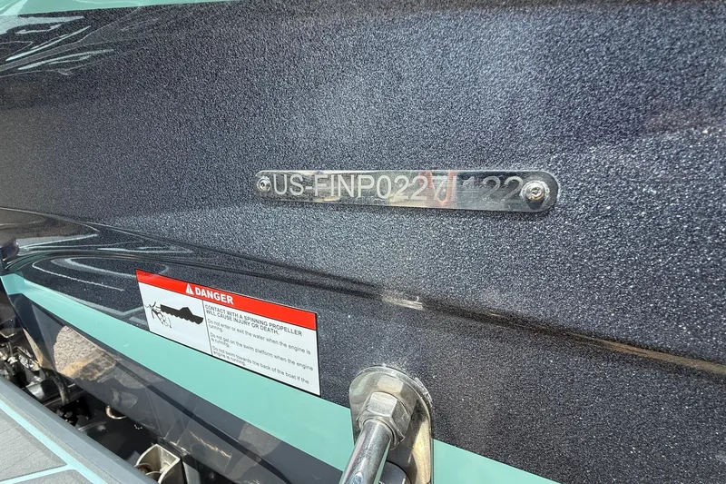 Slide: The Image of 2022 Centurion Ri245 boat hull identification number with safety warning label. - 17
