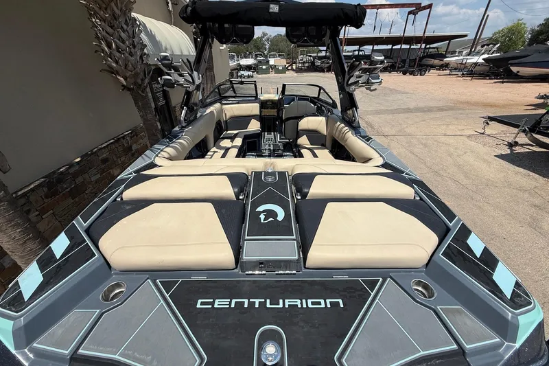 Slide: The Image of 2022 Centurion Ri245 boat with beige seating and sleek design, parked outdoors. - 8