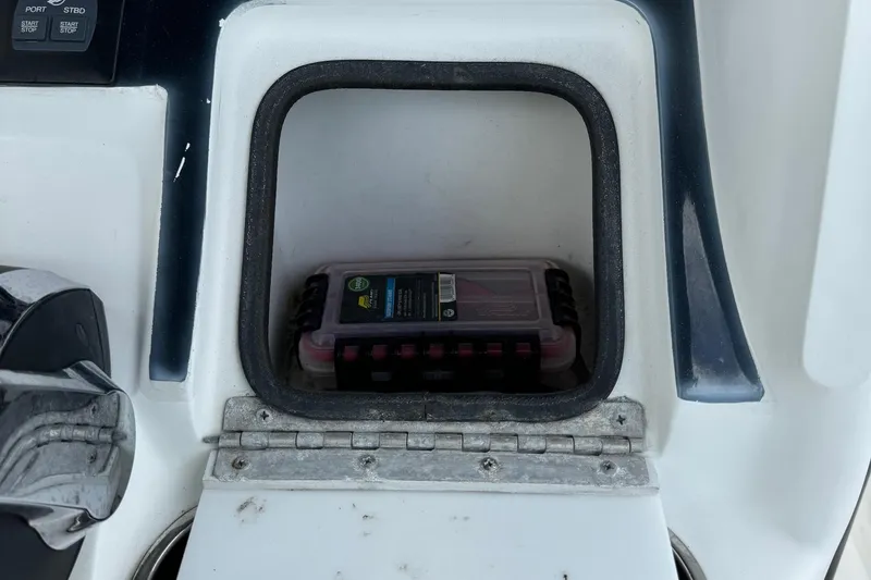 Slide: The Image of Storage compartment on a 2015 Glasstream 280 ZS boat with a plastic container inside. - 19