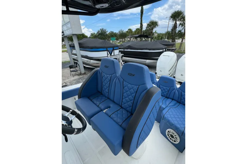 Slide: The Image of Blue leather seats on a 2015 Glasstream 280 ZS boat, parked outdoors. - 21