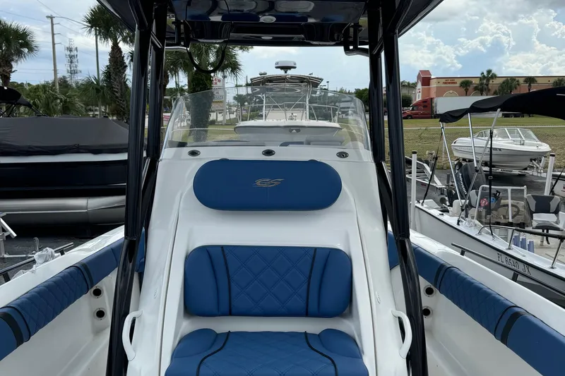 Slide: The Image of 2015 Glasstream 280 ZS boat with blue seating, parked in a marina. - 22