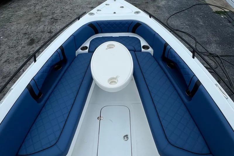 Slide: The Image of 2015 Glasstream 280 ZS boat interior with blue seating and white table. - 26