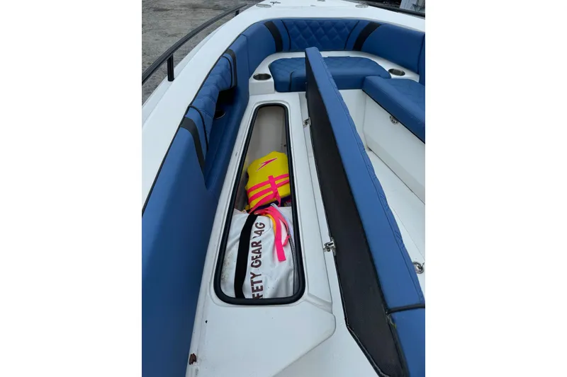 Slide: The Image of 2015 Glasstream 280 ZS boat interior with blue seating and safety gear storage. - 27