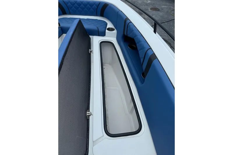 Slide: The Image of 2015 Glasstream 280 ZS boat interior with blue seating and open storage compartment. - 28