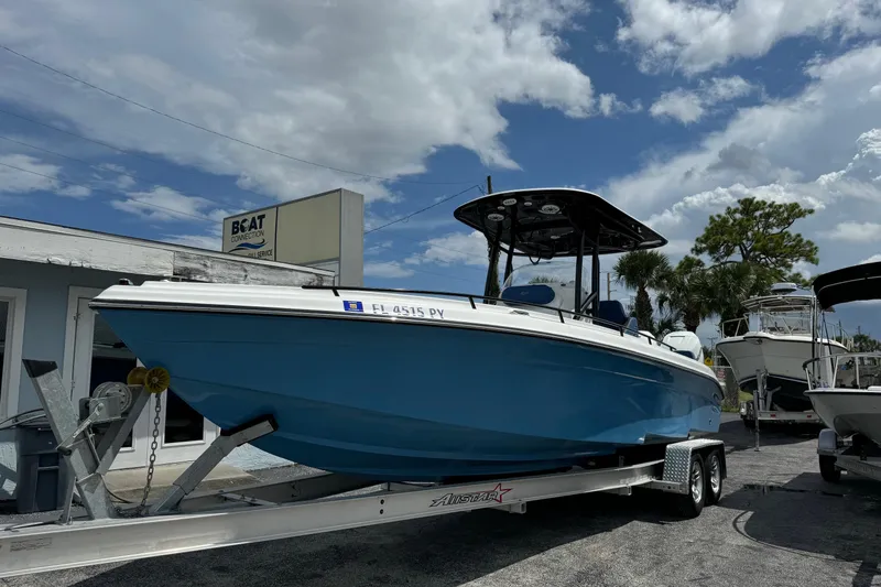 Slide: The Image of 2015 Glasstream 280 ZS boat on trailer at dealership under cloudy sky. - 3