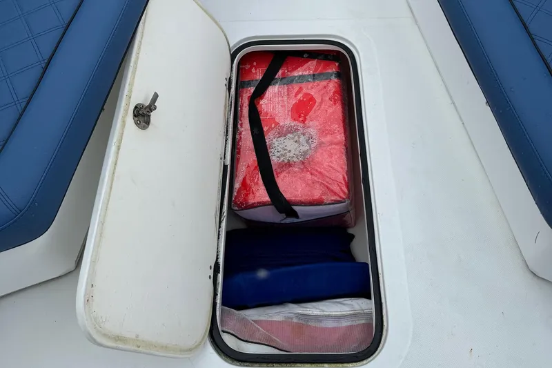 Slide: The Image of Storage compartment on 2015 Glasstream 280 ZS boat with red cooler and blue cushions. - 30