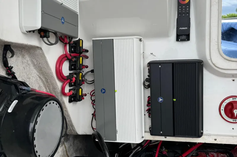 Slide: The Image of Electrical components inside a 2015 Glasstream 280 ZS boat, featuring wiring and control panels. - 32