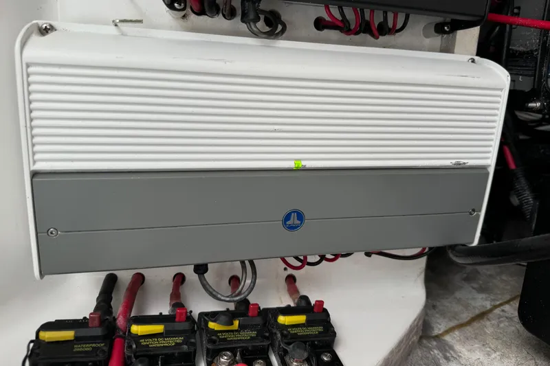 Slide: The Image of Electrical panel in a 2015 Glasstream 280 ZS boat, featuring wiring and circuit breakers. - 37