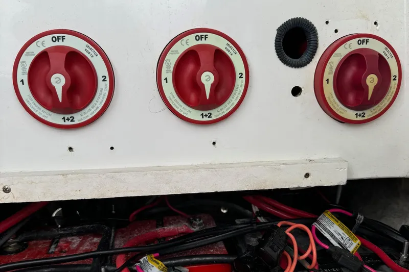 Slide: The Image of Battery switches on a 2015 Glasstream 280 ZS boat, featuring red dials and wiring. - 39