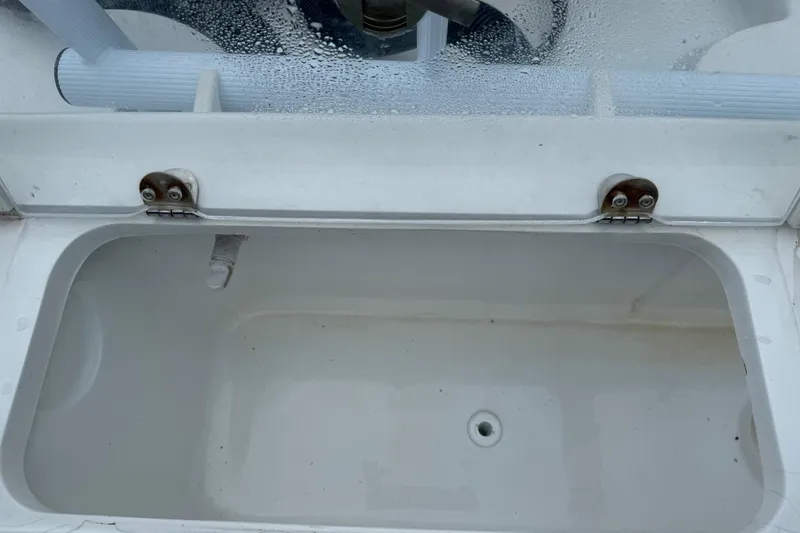 Slide: The Image of Open storage compartment on a 2015 Glasstream 280 ZS boat, showing interior details. - 43
