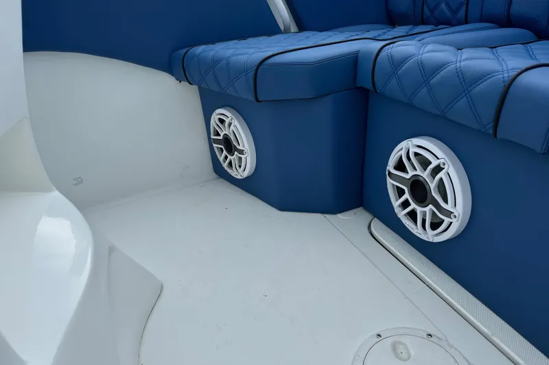 Slide: The Image of 2015 Glasstream 280 ZS boat interior with blue seating and white speakers. - 46