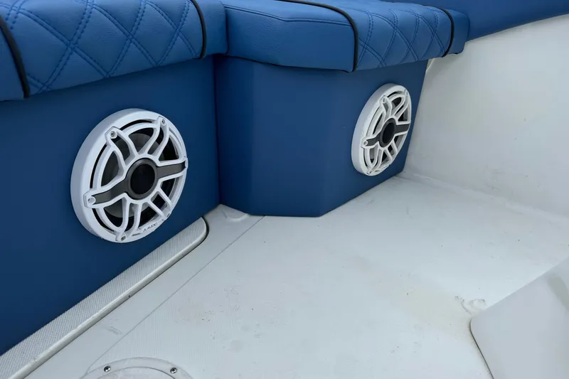 Slide: The Image of 2015 Glasstream 280 ZS boat interior with blue seating and white speakers. - 47