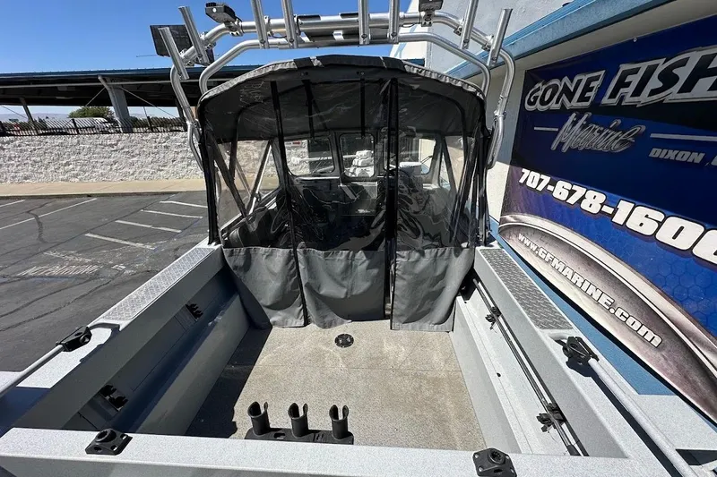 Slide: The Image of 2017 Duckworth 18 Advantage boat with canopy, parked near a marine service center. - 11