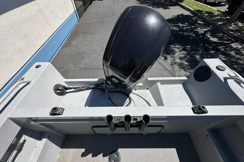 Slide: The Image of 2017 Duckworth 18 Advantage boat with outboard motor, parked on pavement. - 15