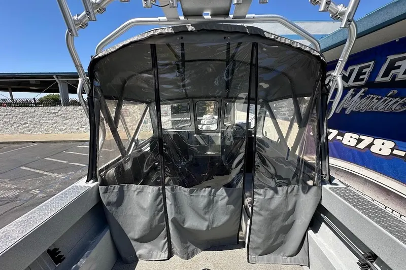 Slide: The Image of 2017 Duckworth 18 Advantage boat with protective canopy in a parking lot. - 16