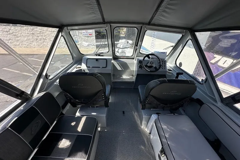 Slide: The Image of Interior of a 2017 Duckworth 18 Advantage boat, featuring seating and steering console. - 17