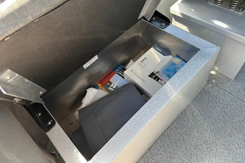 Slide: The Image of Storage compartment in 2017 Duckworth 18 Advantage boat, containing various items and manuals. - 22
